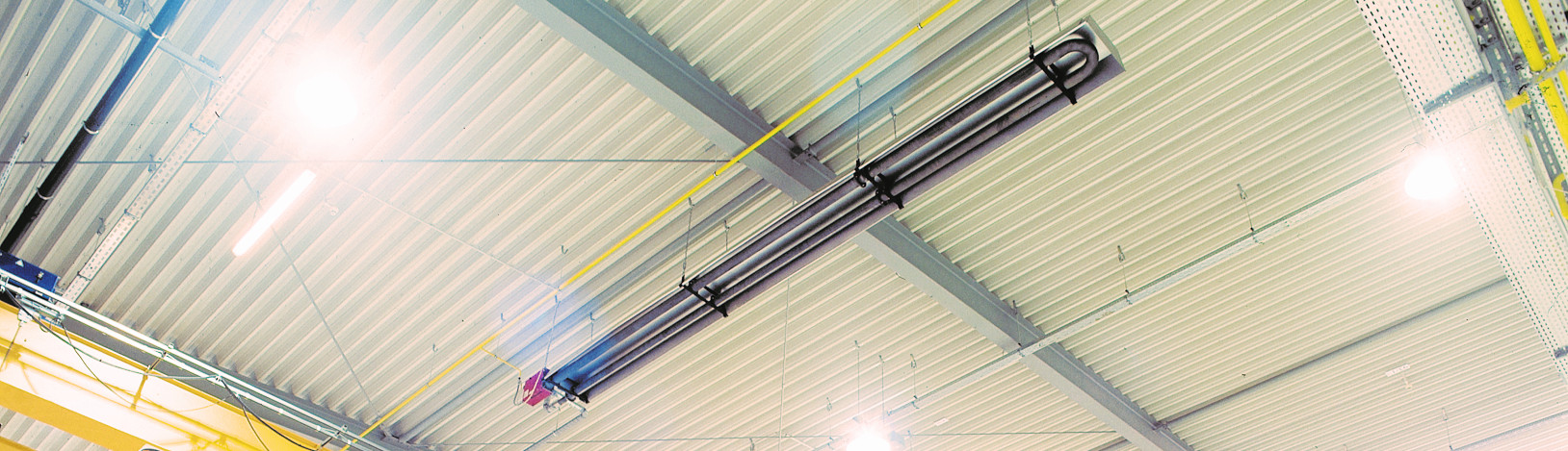 The tube heater deltaSchwank under the ceiling of an industrial building.