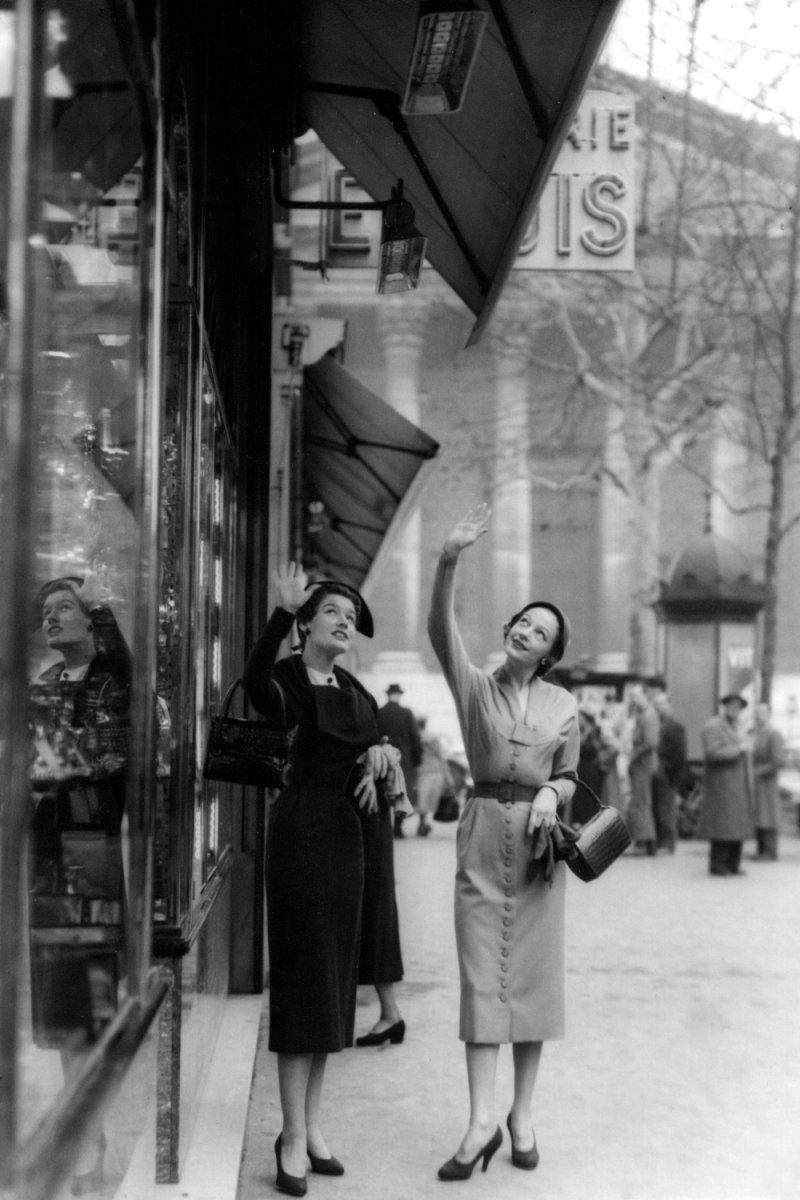 Two ladies standing under a Schwank infrared heater on Rue Tronchet, Paris in 1948.
