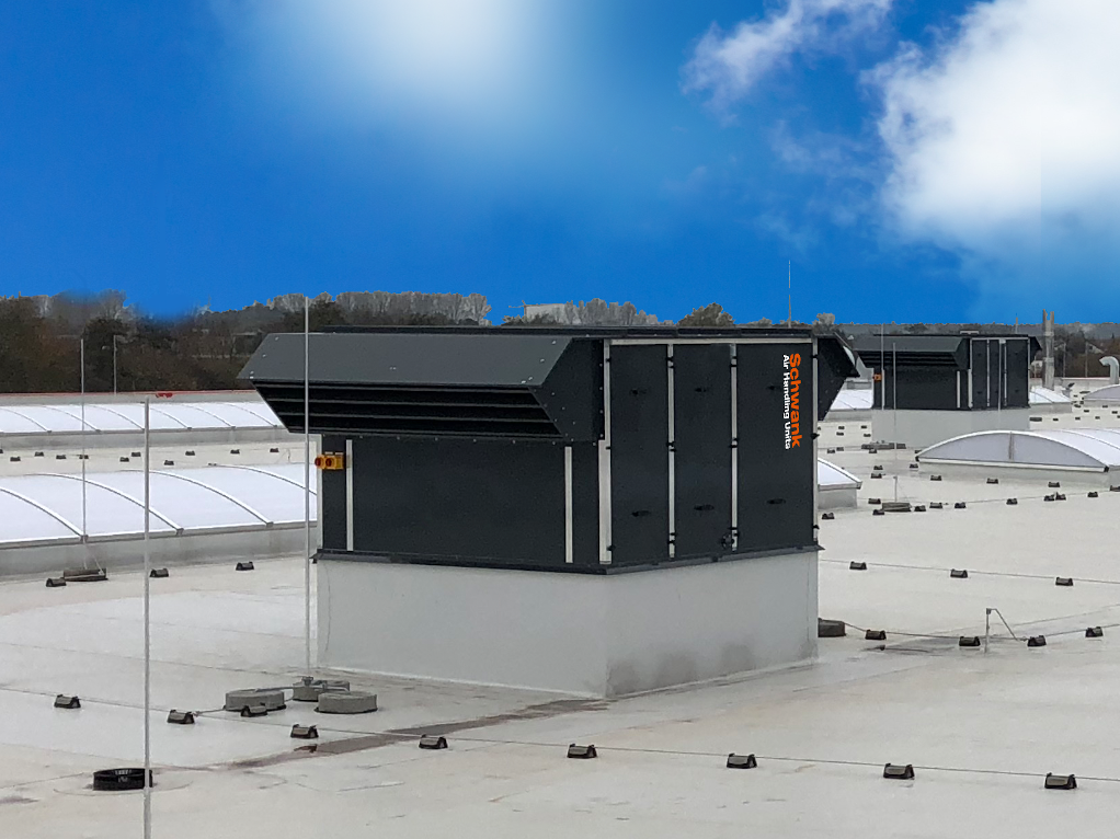 An air handling unit on the roof of an industrial building.