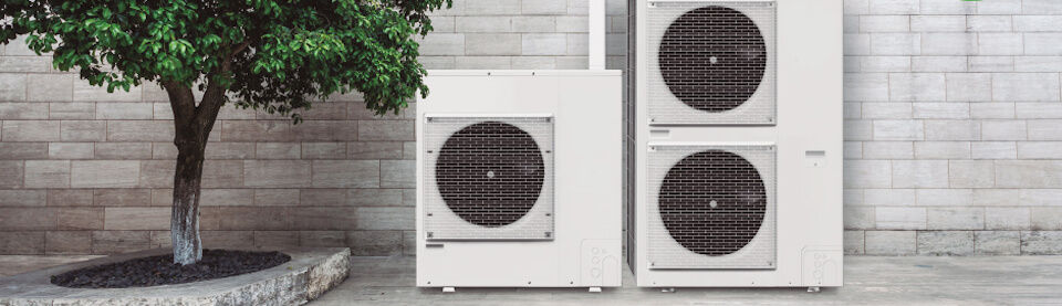 Two electric heat pumps from Schwank outside a building.